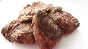 A pile of freeze-dried, textured reddish-brown Sheep Spleens on a plain white background.